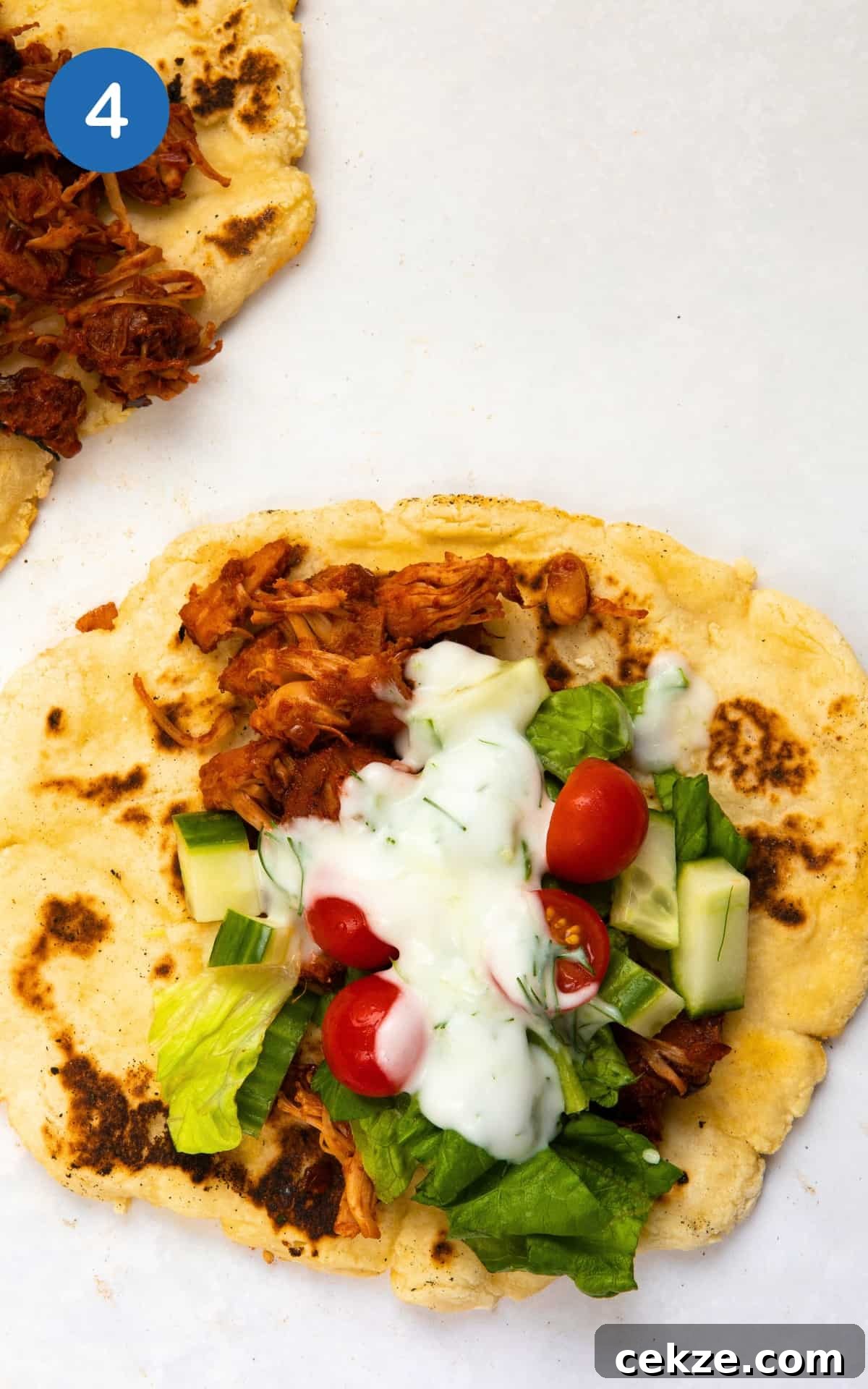 jackfruit served in flatbread with fresh vegetables and tzatziki.