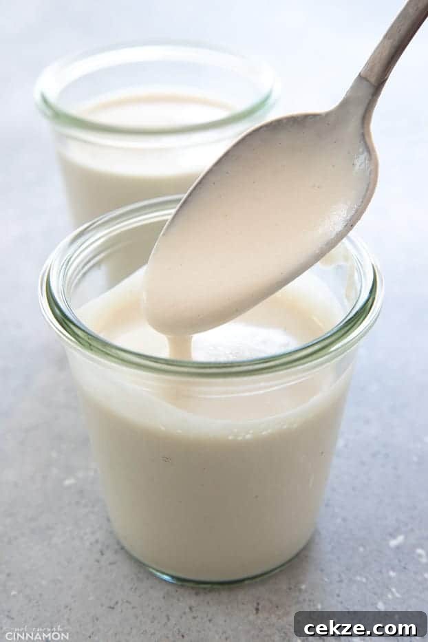 25 Must-Try Recipes from 2020: Top Fan Favorites 20 a small glass of homemade vegan cashew cream with a silver spoon