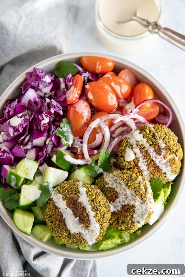 25 Must-Try Recipes from 2020: Top Fan Favorites 6 overhead shot of a healthy baked falafel bowl drizzled with tahini sauce