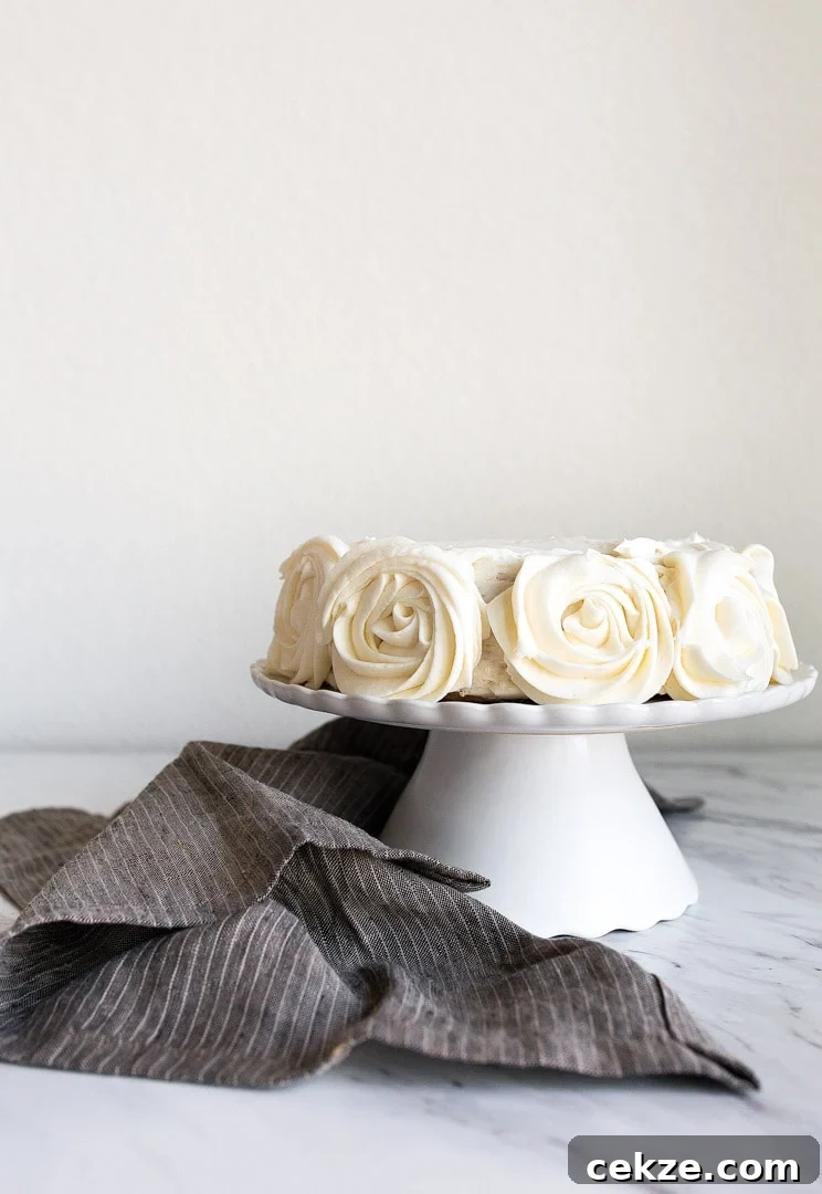 Mini Vanilla Cake for Two people in a 6" small round cake pan. Vanilla buttercream roses on the sides.