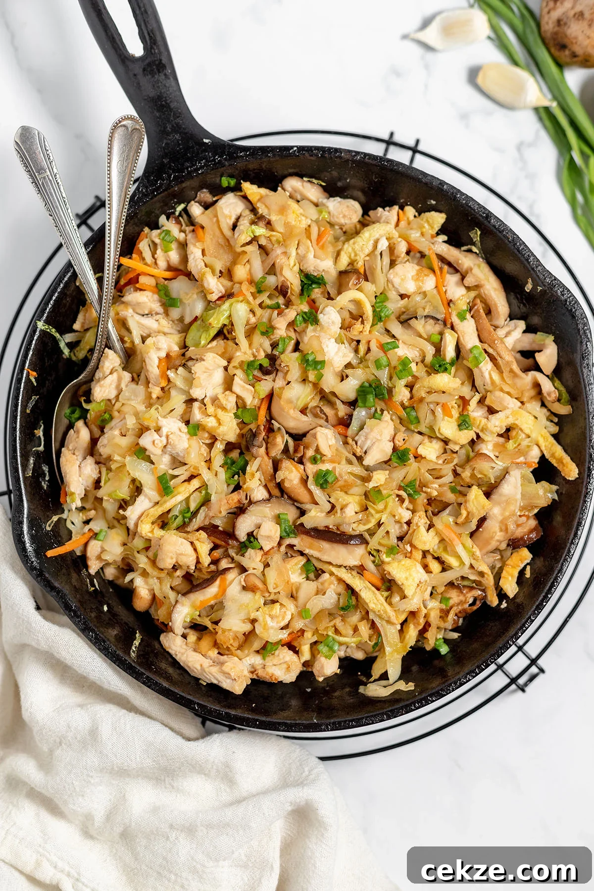 Moo Shu Chicken is in a cast-iron skillet.