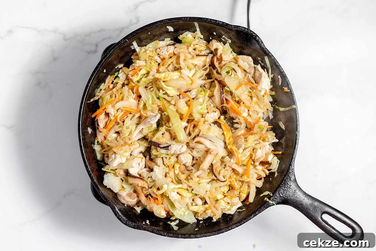 Moo Shu Chicken is in a cast-iron skillet.