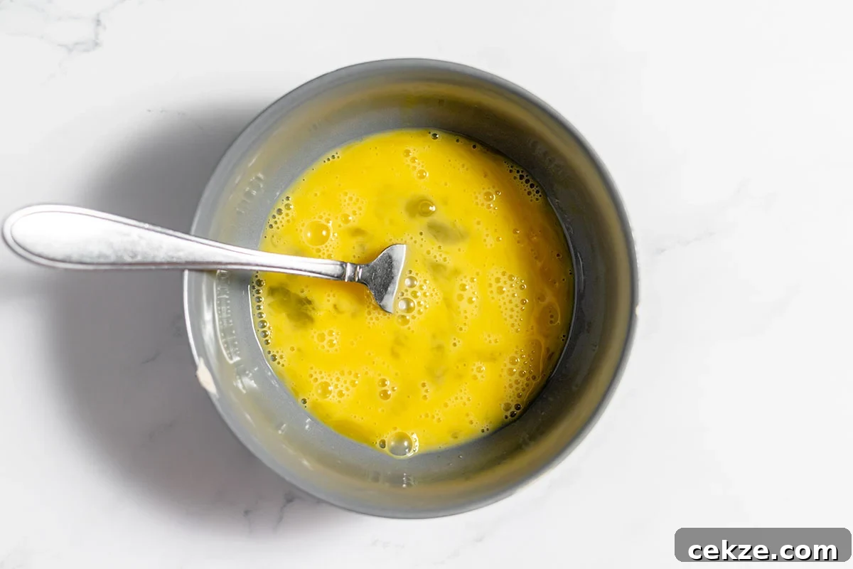 Whisked eggs in a bowl.