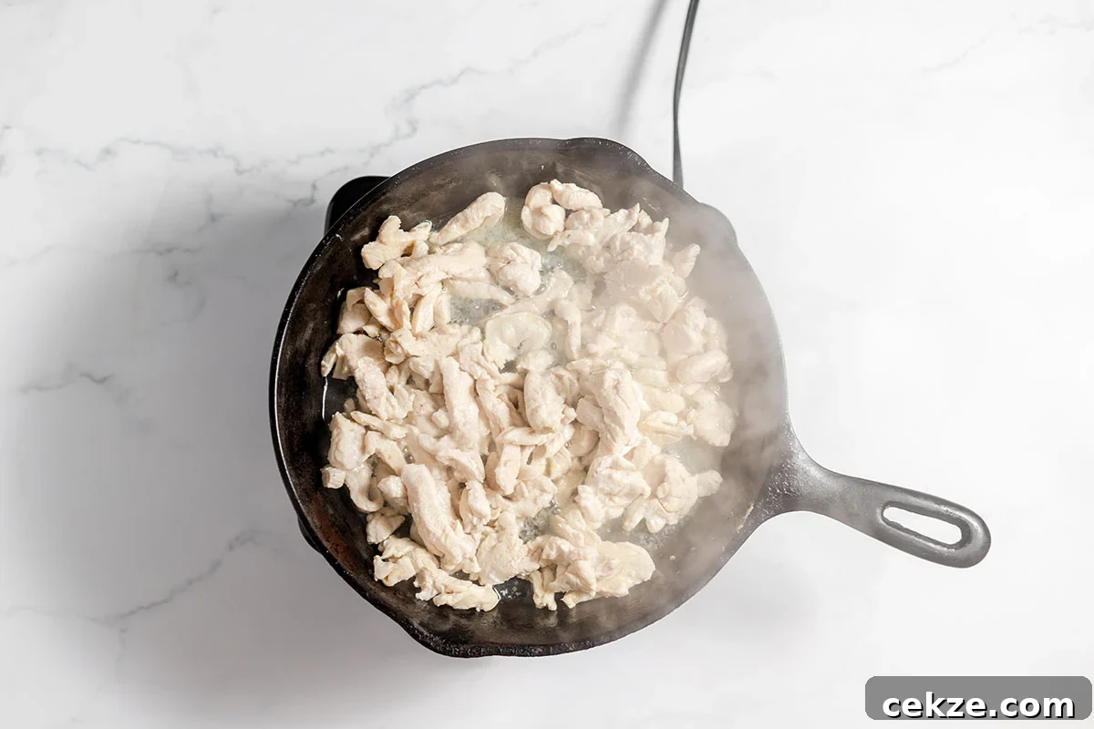 Cooked chicken strips in a cast iron skillet.