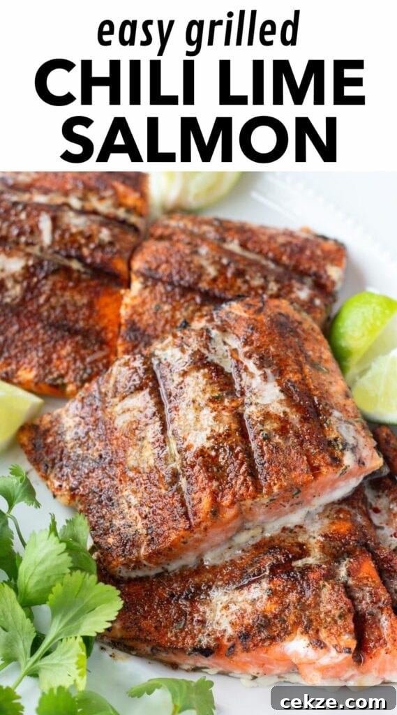 15-Minute Chili Lime Grilled Salmon Recipe 13 Pinterest image showing a close up of grilled salmon filets on a white platter with lime wedges and fresh herbs next to them. There's a white rectangle at the top with black lettering that reads