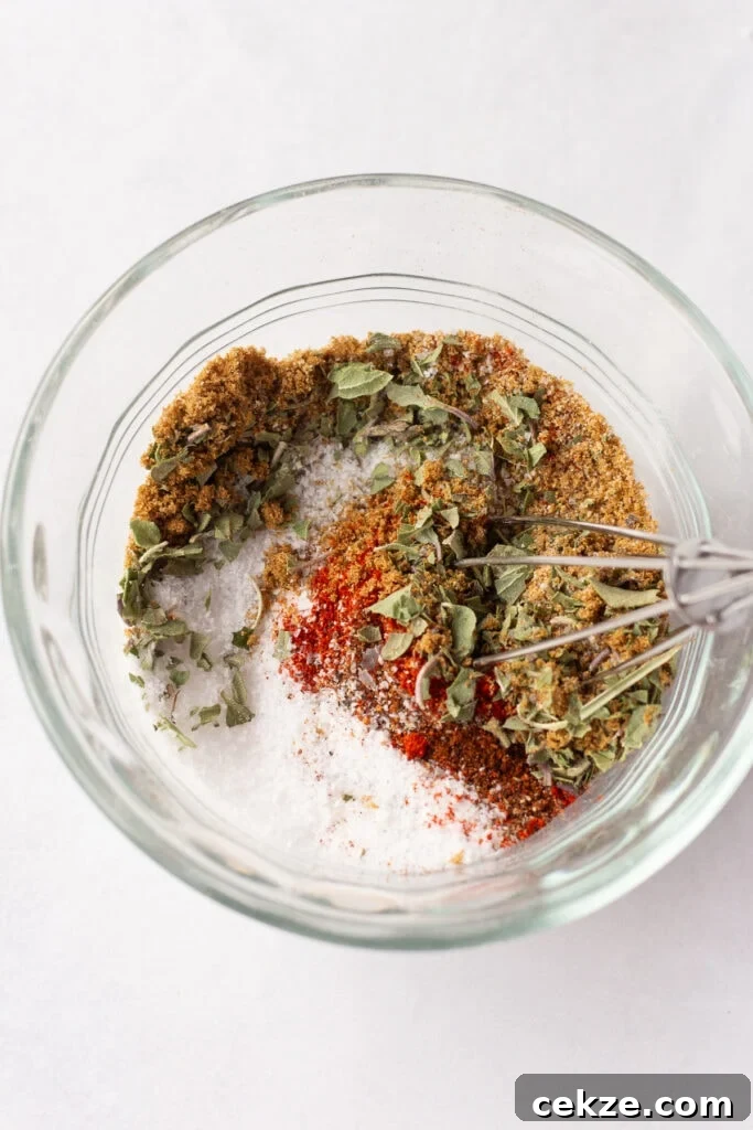 15-Minute Chili Lime Grilled Salmon Recipe 4 A small glass bowl with spices in it being stirred by a small whisk.