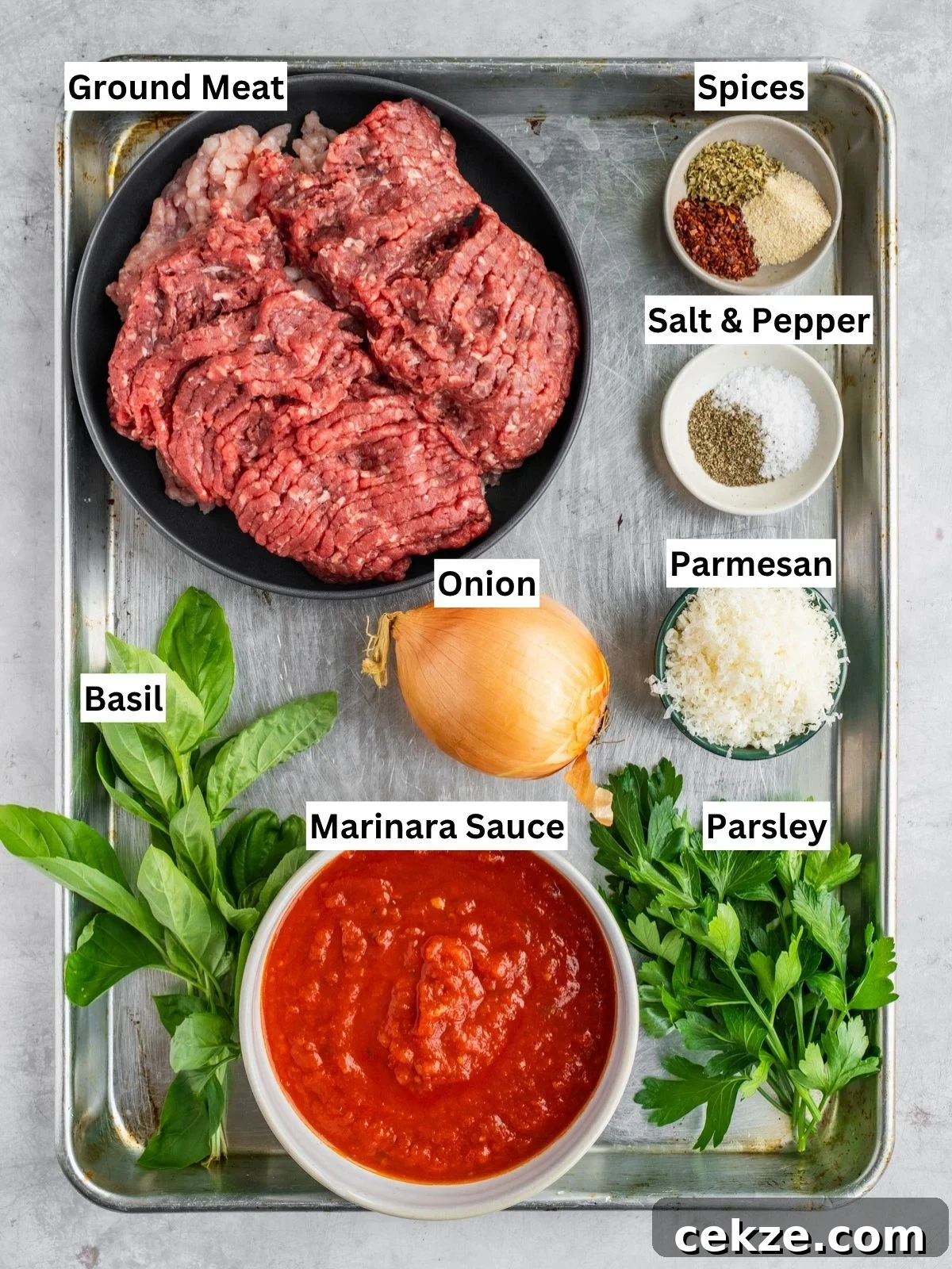 Juicy Italian Meatballs Without Breadcrumbs — Recipe & Tips 3 Italian Meatballs in Sauce recipe ingredients with individual labels on a metal tray.