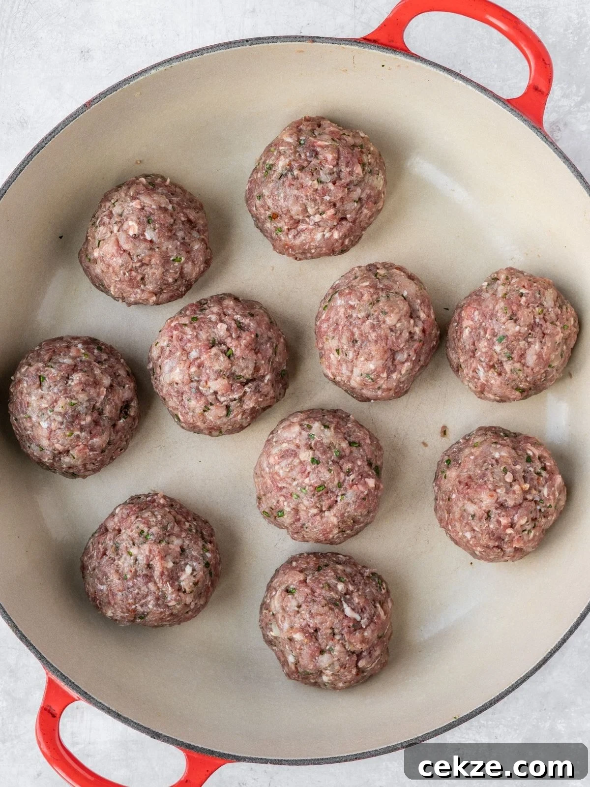 Juicy Italian Meatballs Without Breadcrumbs — Recipe & Tips 6 Raw meatballs in a shallow pan.