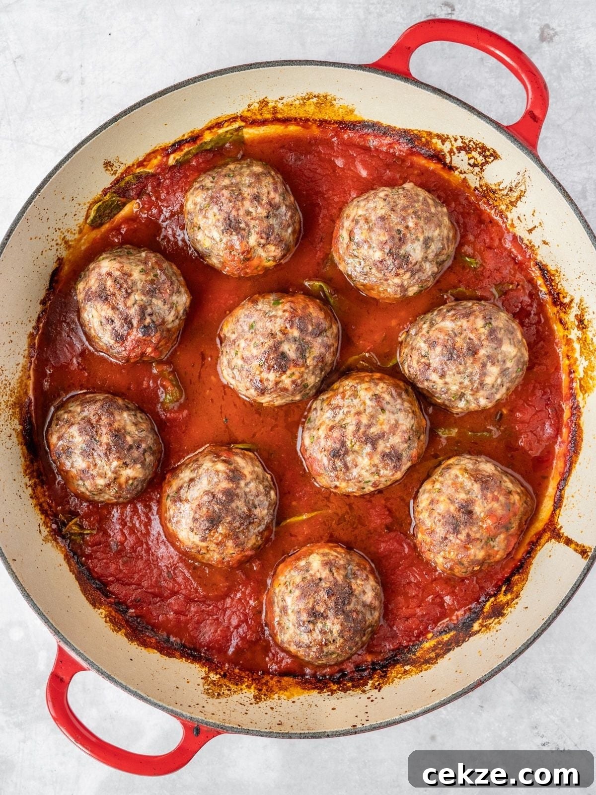 Juicy Italian Meatballs Without Breadcrumbs — Recipe & Tips 8 Italian Meatballs in a skillet simmering in marinara.
