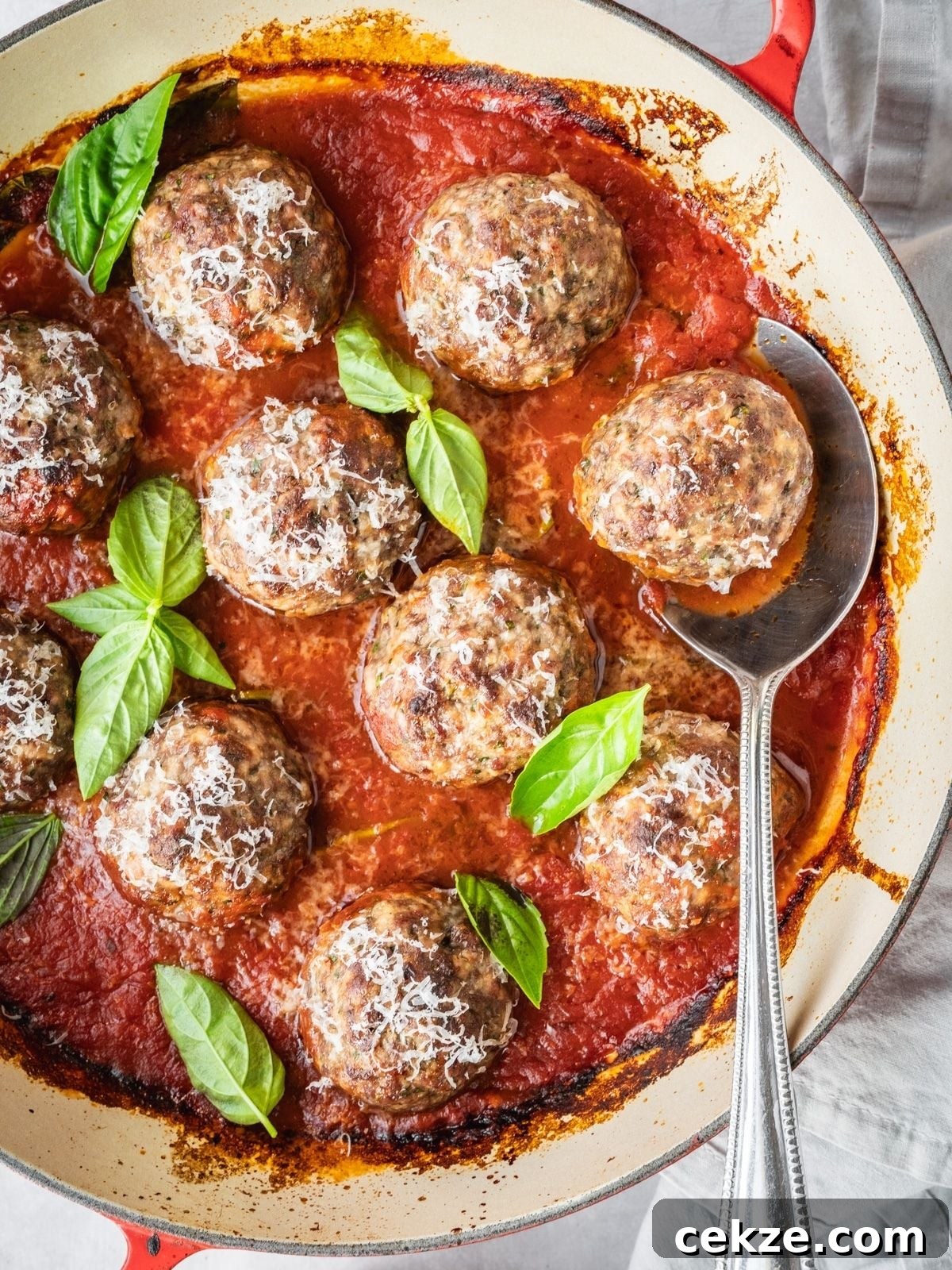 Juicy Italian Meatballs Without Breadcrumbs — Recipe & Tips 10 Italian Meatballs simmering in marinara, garnished with fresh basil and Parmesan.