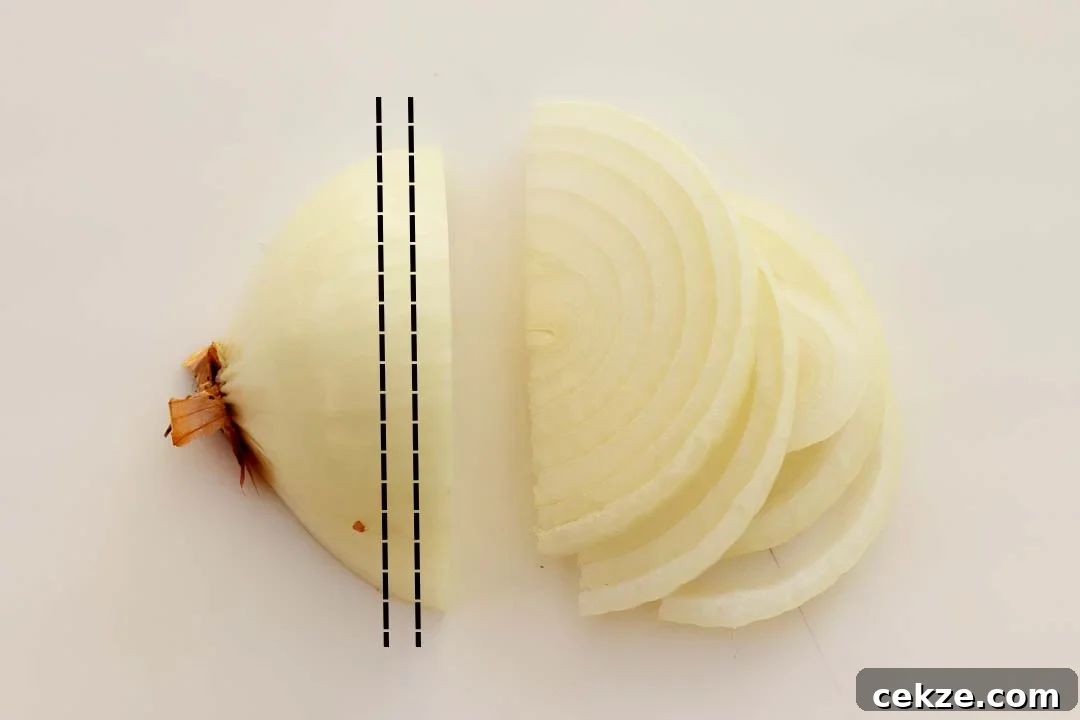 Half a peeled onion that's been sliced
