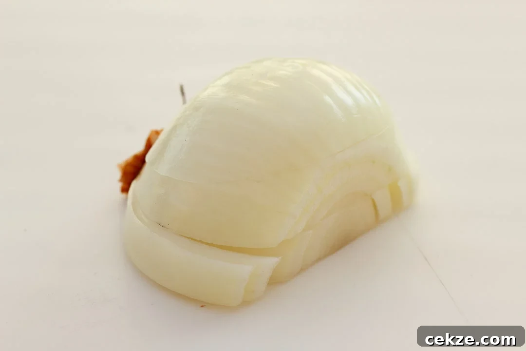 Half a peeled onion that's been sliced twice horizontally