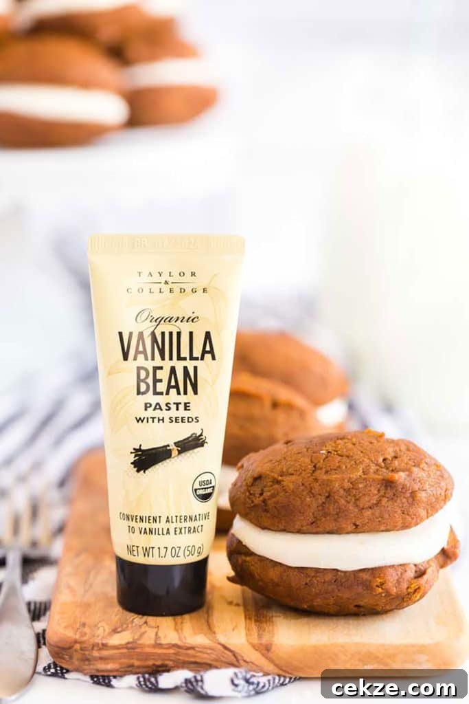 Whoopie cookie next to a vanilla bean container.