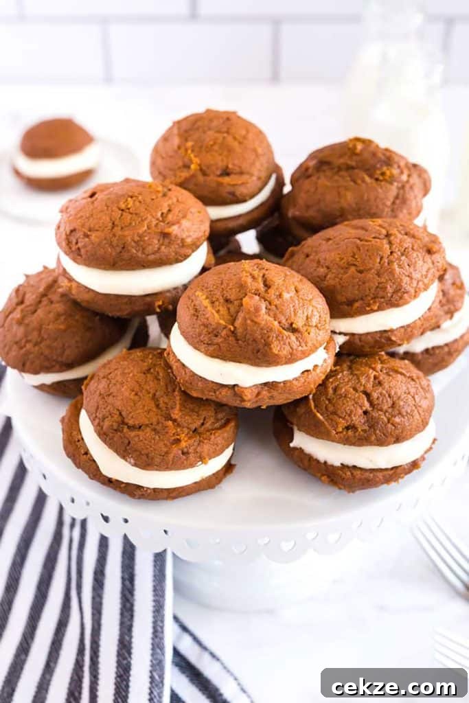 A group of homemade whoopie cookies on a cake platter.
