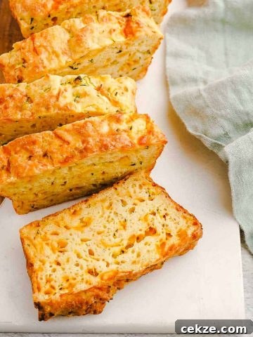 Zucchini Cheese Bread Slices on Marble and Wood Board