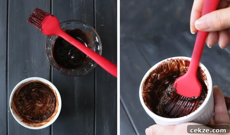chocolate paste mixture being brushed on the inside of ramekins