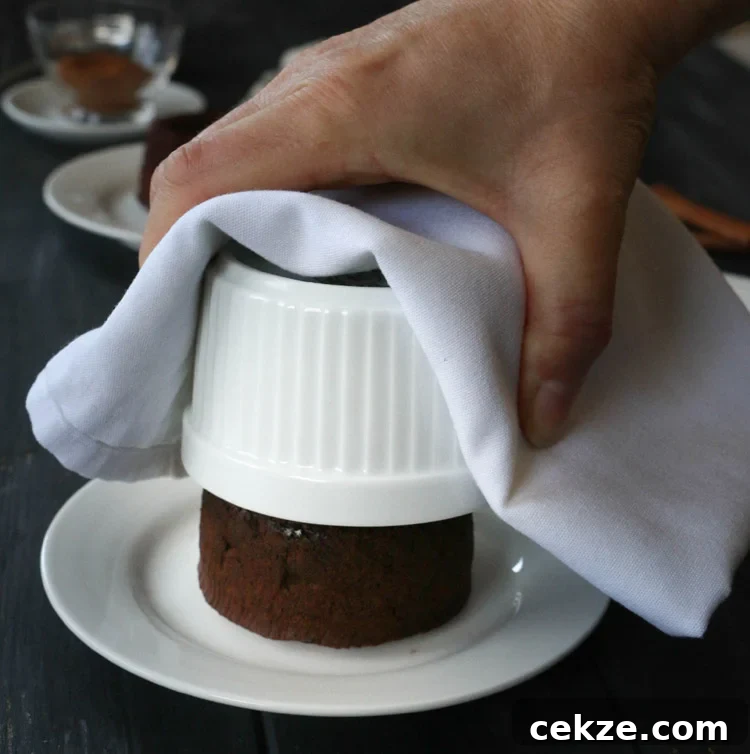 Lifting ramekin up from a chocolate lava cake