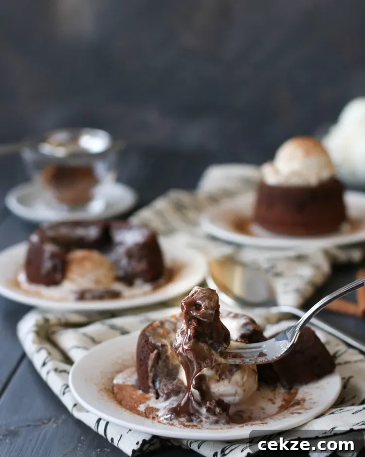 a forkful of spicy molten chocolate lava cake with the fudgy center dripping off the fork