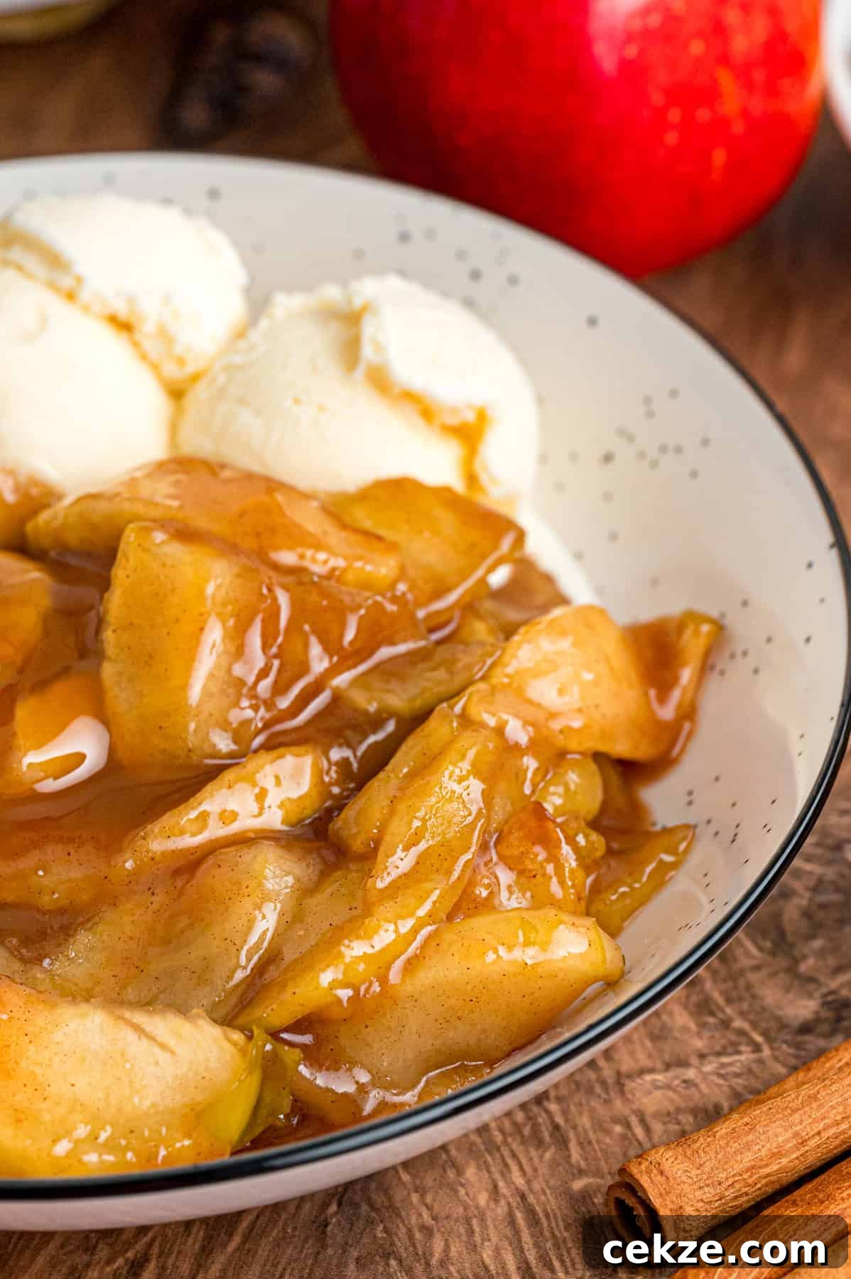 Granny Smith apple slices are tossed with sugar and spices then baked until tender in this Baked Apples recipe. Serve with ice cream. A bowl of baked apples with vanilla ice cream