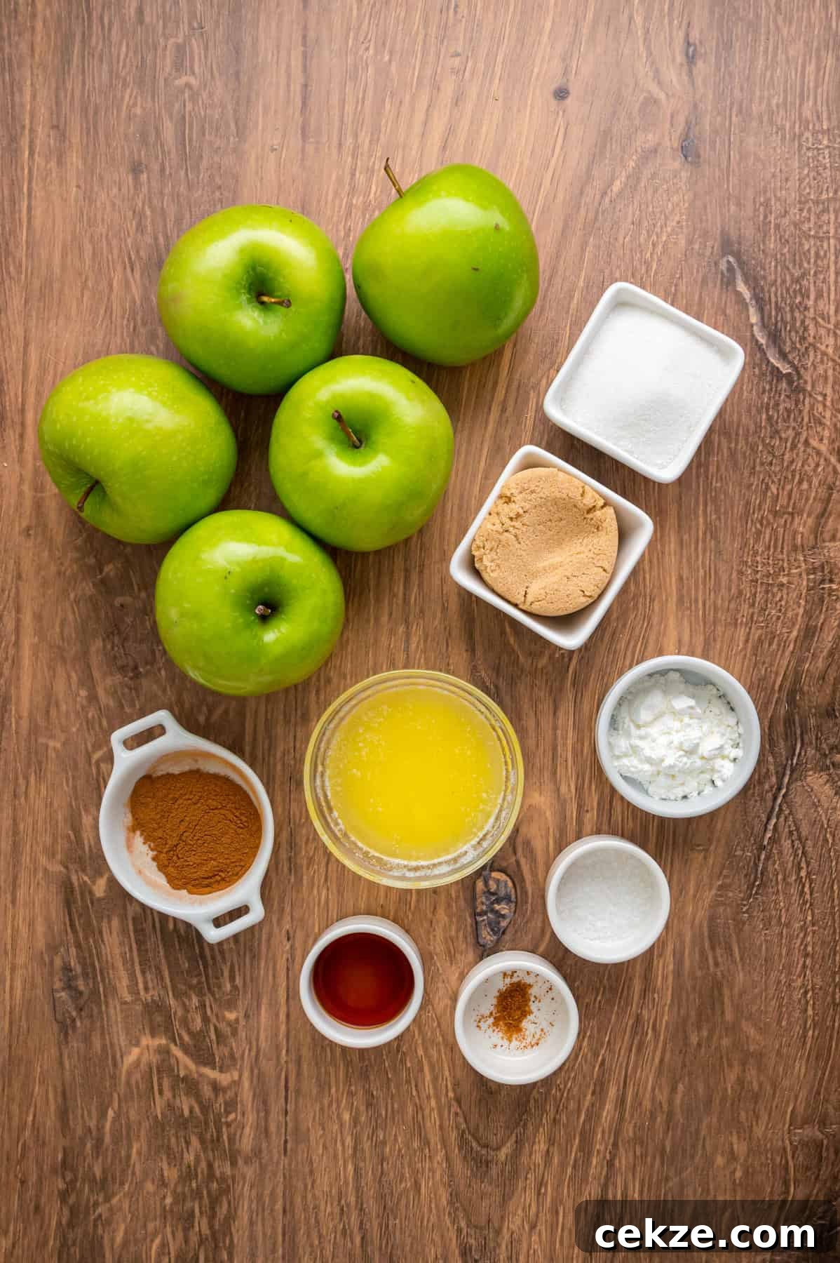 Granny Smith apple slices are tossed with sugar and spices then baked until tender in this Baked Apples recipe. Serve with ice cream. Overhead view of ingredients needed to make baked apples