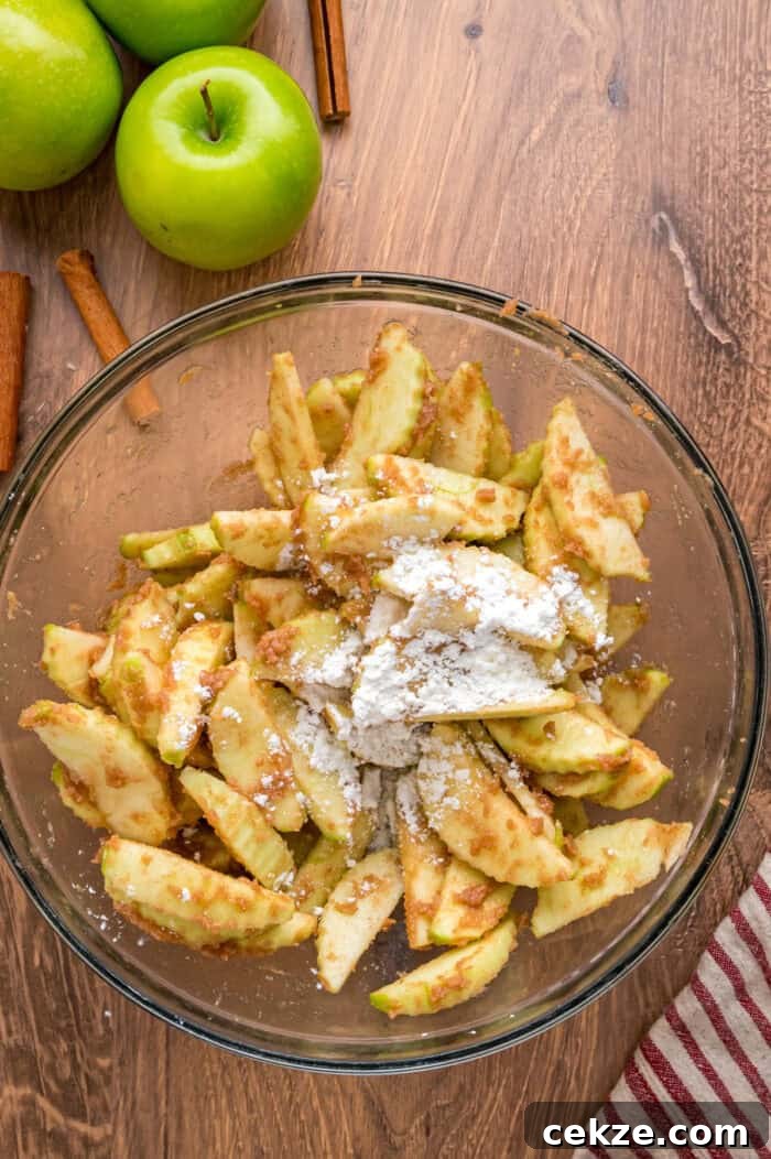 Granny Smith apple slices are tossed with sugar and spices then baked until tender in this Baked Apples recipe. Serve with ice cream. Cornstarch added to spiced apple slices