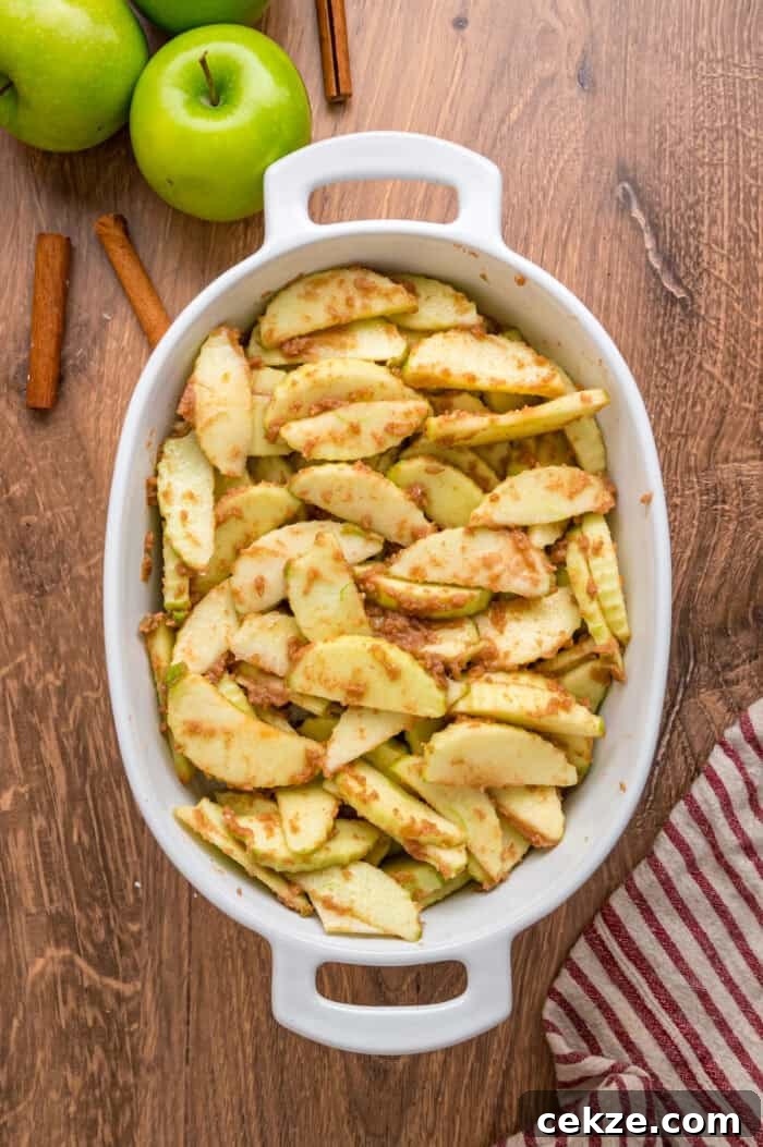 Granny Smith apple slices are tossed with sugar and spices then baked until tender in this Baked Apples recipe. Serve with ice cream. Spiced apple slices in a baking dish