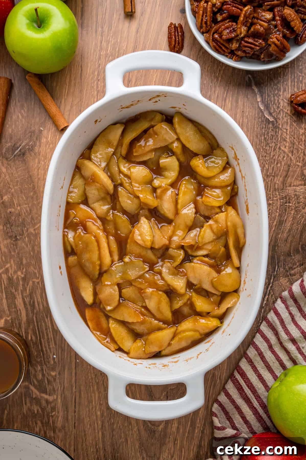 Granny Smith apple slices are tossed with sugar and spices then baked until tender in this Baked Apples recipe. Serve with ice cream. Baked apples in a baking dish