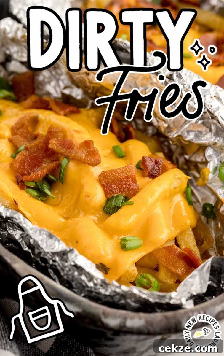 Loaded Dirty Fries Recipe: Crispy Fries Topped with Cheese & Bacon 2 close up shot of a aluminum foil of Dirty Fries topped with cheese then garnished with bacon bits and green onions