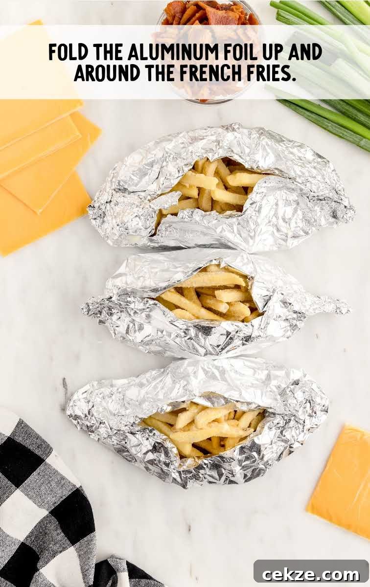 Loaded Dirty Fries Recipe: Crispy Fries Topped with Cheese & Bacon 6 French fries wrapped in sheets of aluminum foil
