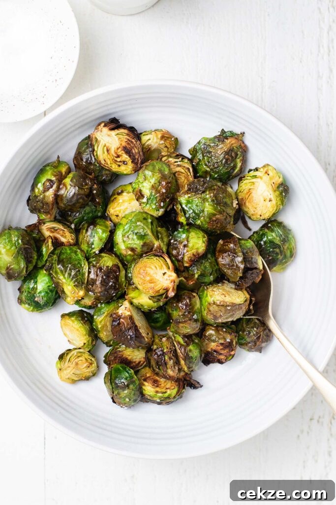 A bowl of air fryer brussels sprouts, perfectly crispy on the outer leaves.