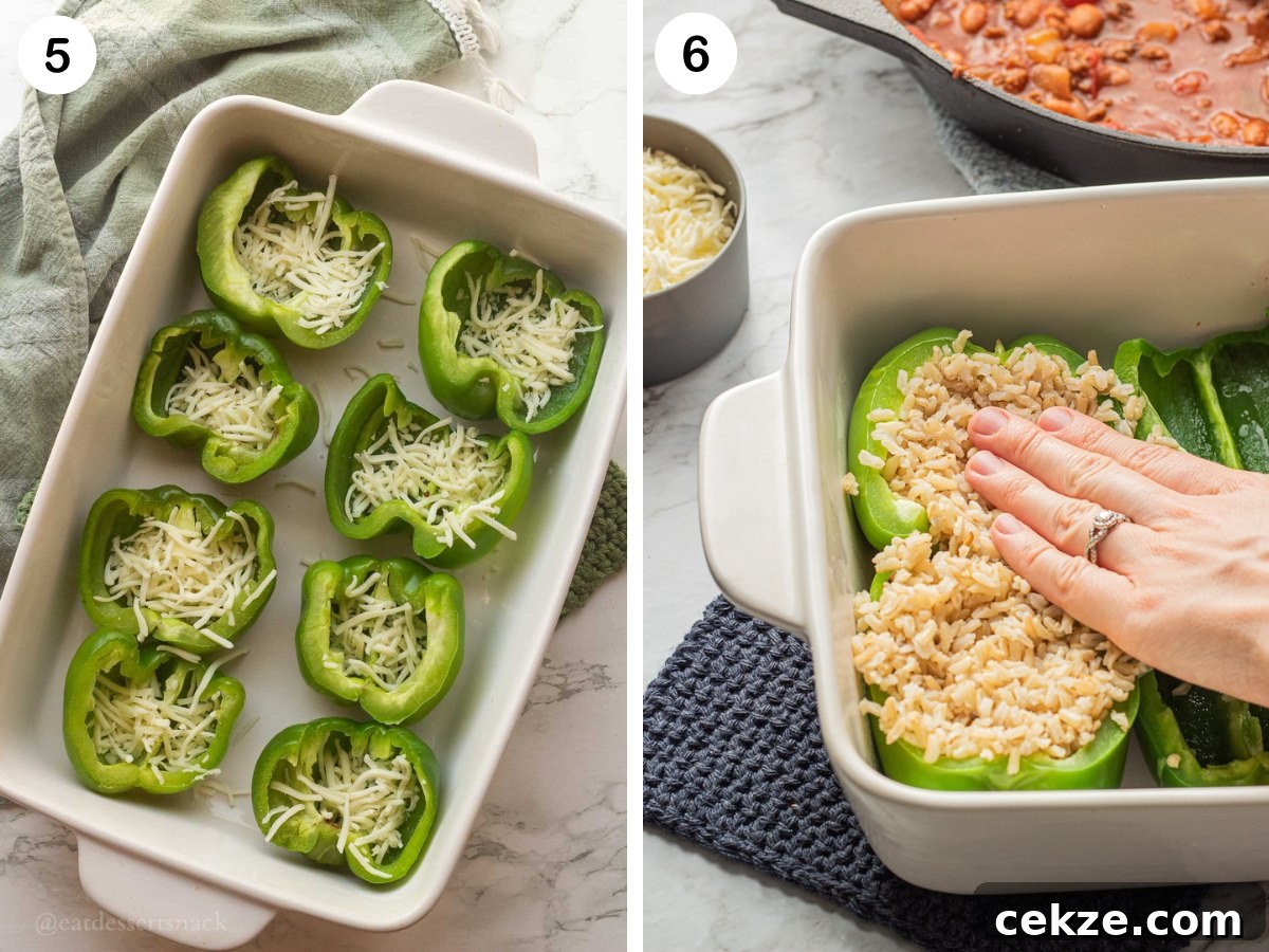 Green pepper halves with cheese in white pan, and hand pressing cooked rice into pepper halves.
