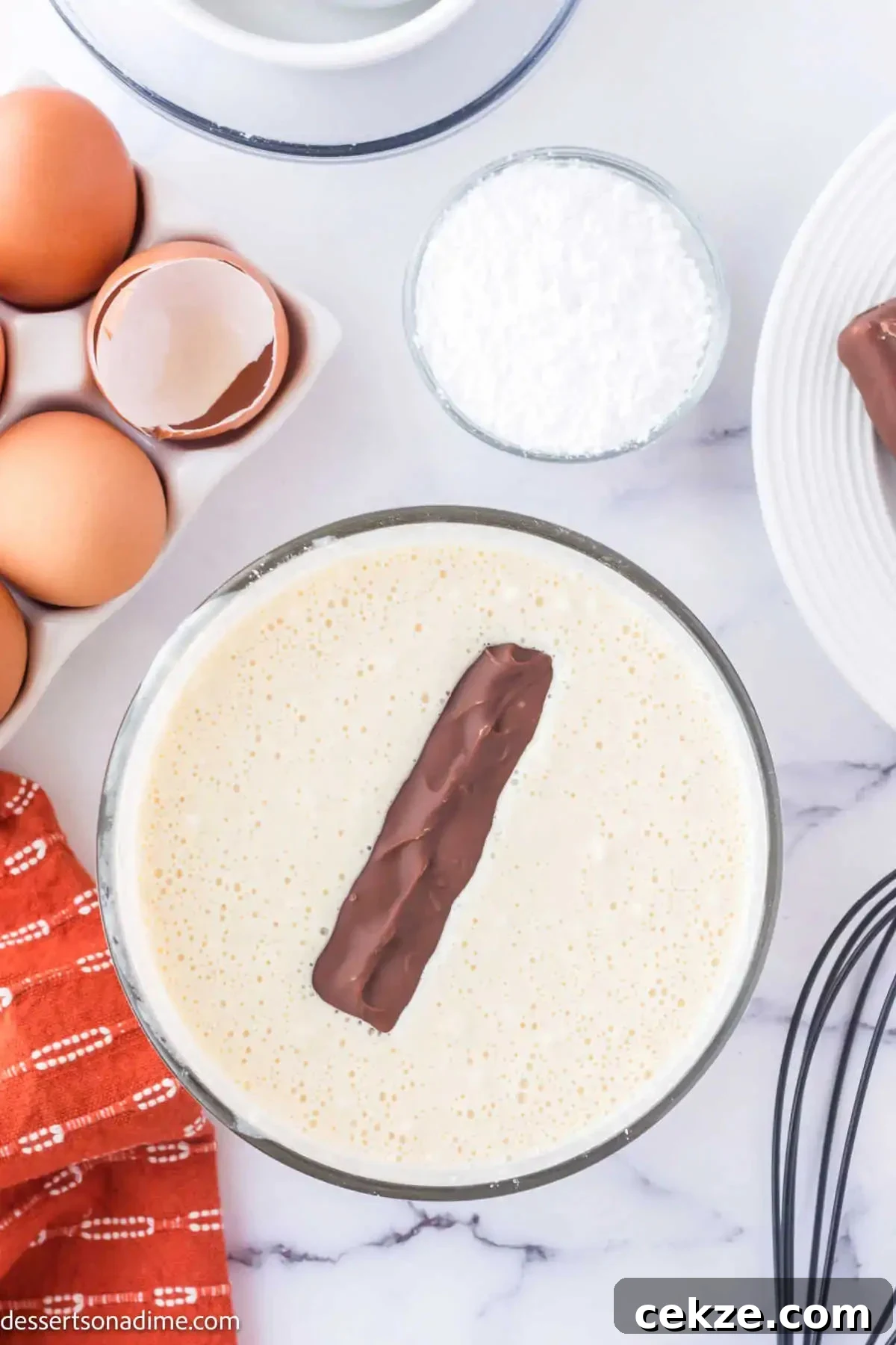 Crispy Deep-Fried Snickers: How to Make the Perfect Indulgent Treat 6 Snickers bar coated in batter in a bowl.