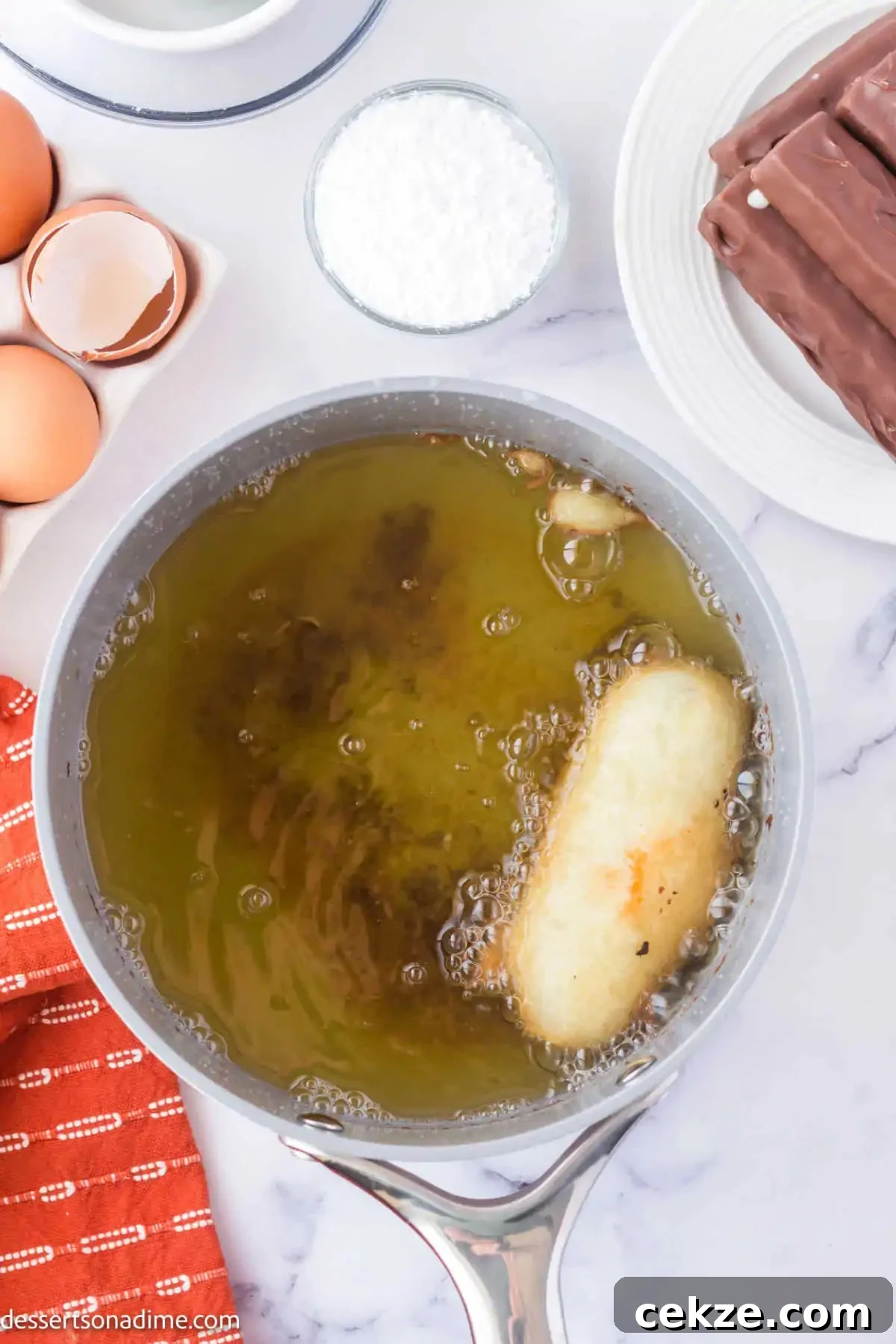 Crispy Deep-Fried Snickers: How to Make the Perfect Indulgent Treat 7 Snickers in hot oil.
