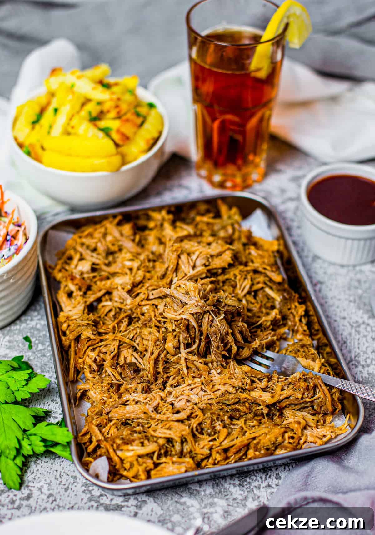 Tender Slow Cooker Pulled Pork Recipe for Sandwiches 2 Crock Pot Pulled Pork on tray with form and French fries in bowl