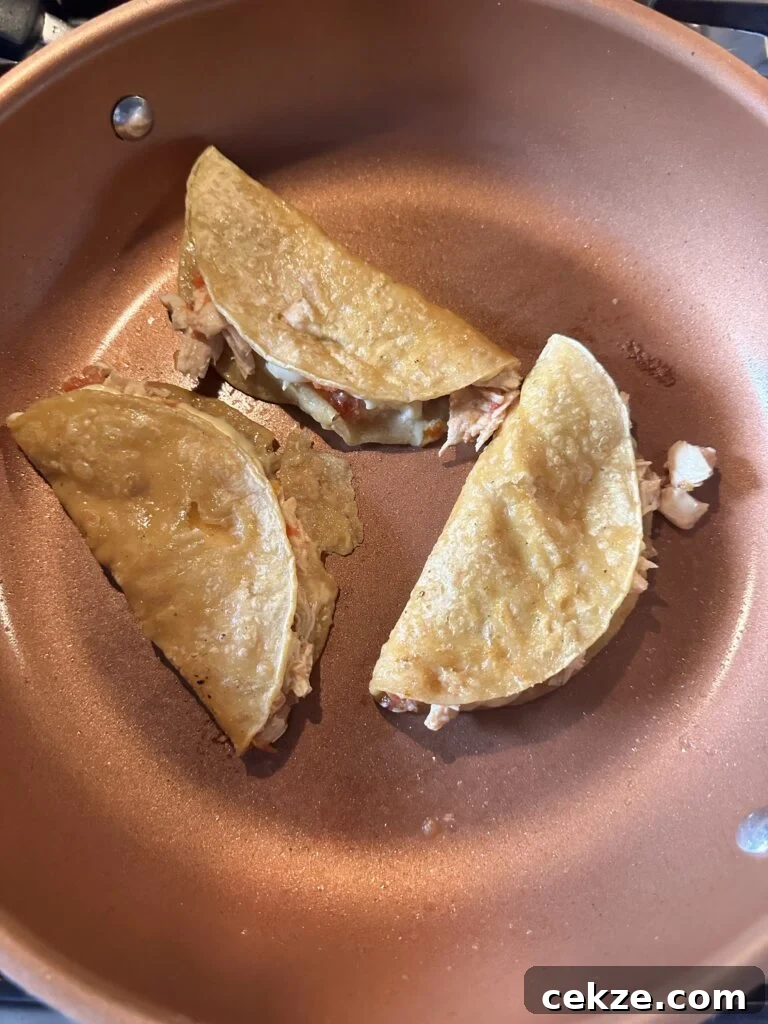 The chicken and cheese tacos folded over to crisp in the pan