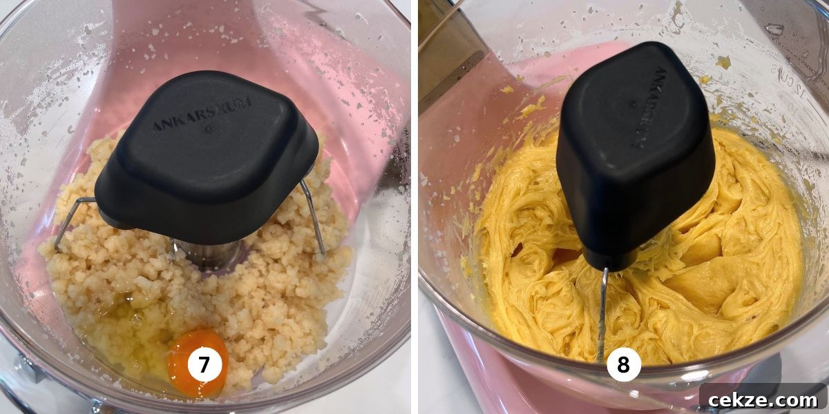 How to Make Classic Cream Puffs: Light Choux Pastry Recipe 8 Adding eggs one at a time to choux pastry mixture in a cloudy pink colored Ankarsrum assistent original mixer.
