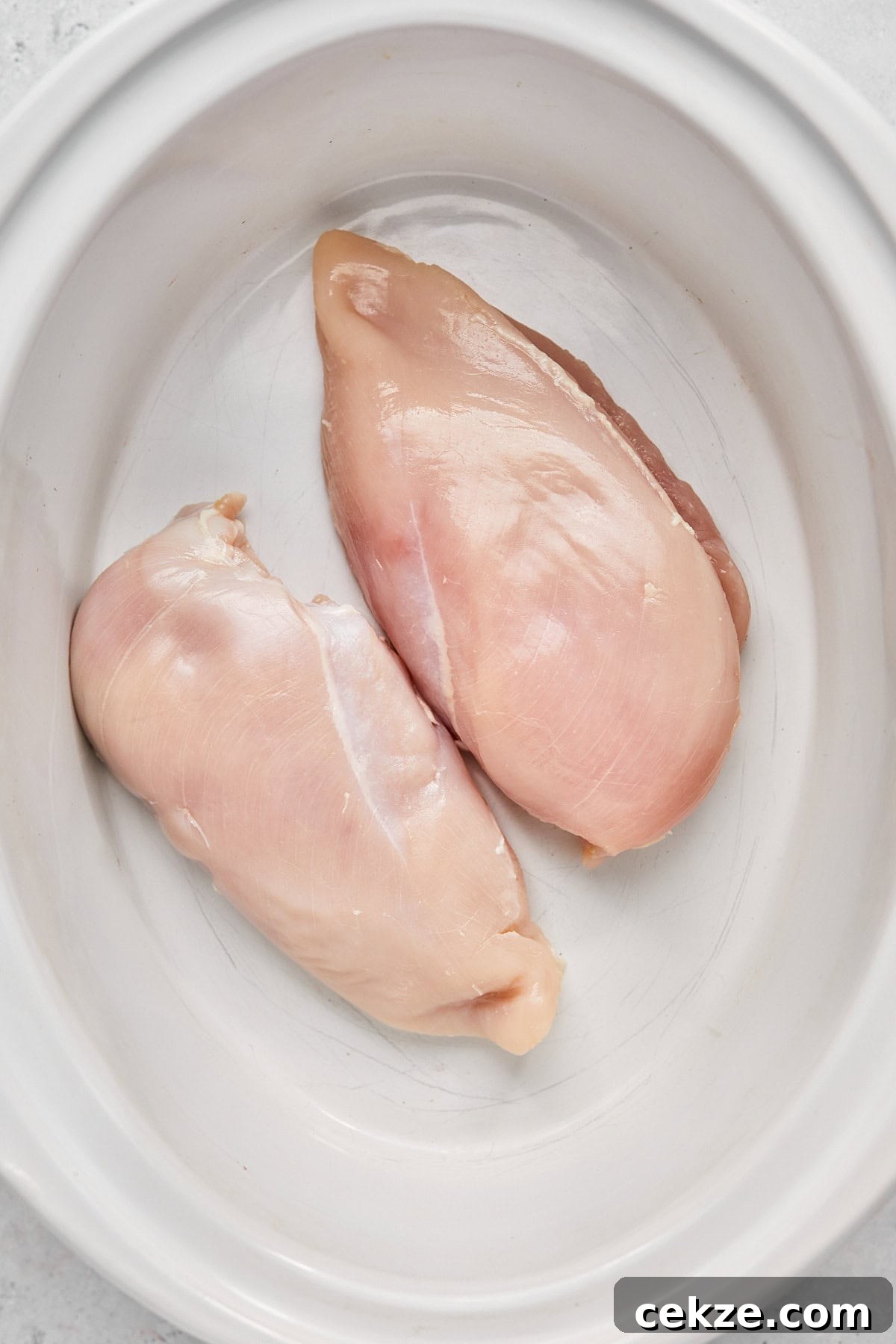 raw chicken in a slow cooker