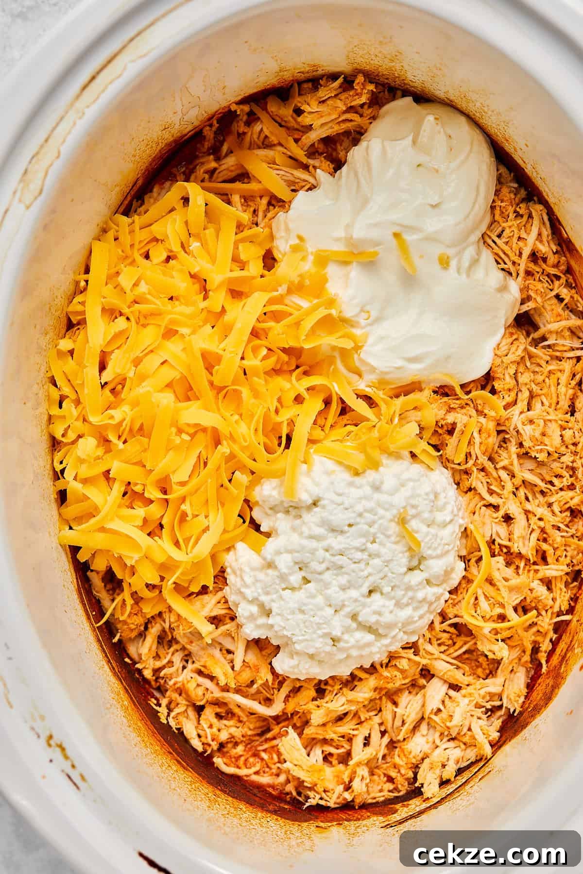adding the rest of the ingredients to the slow cooker 