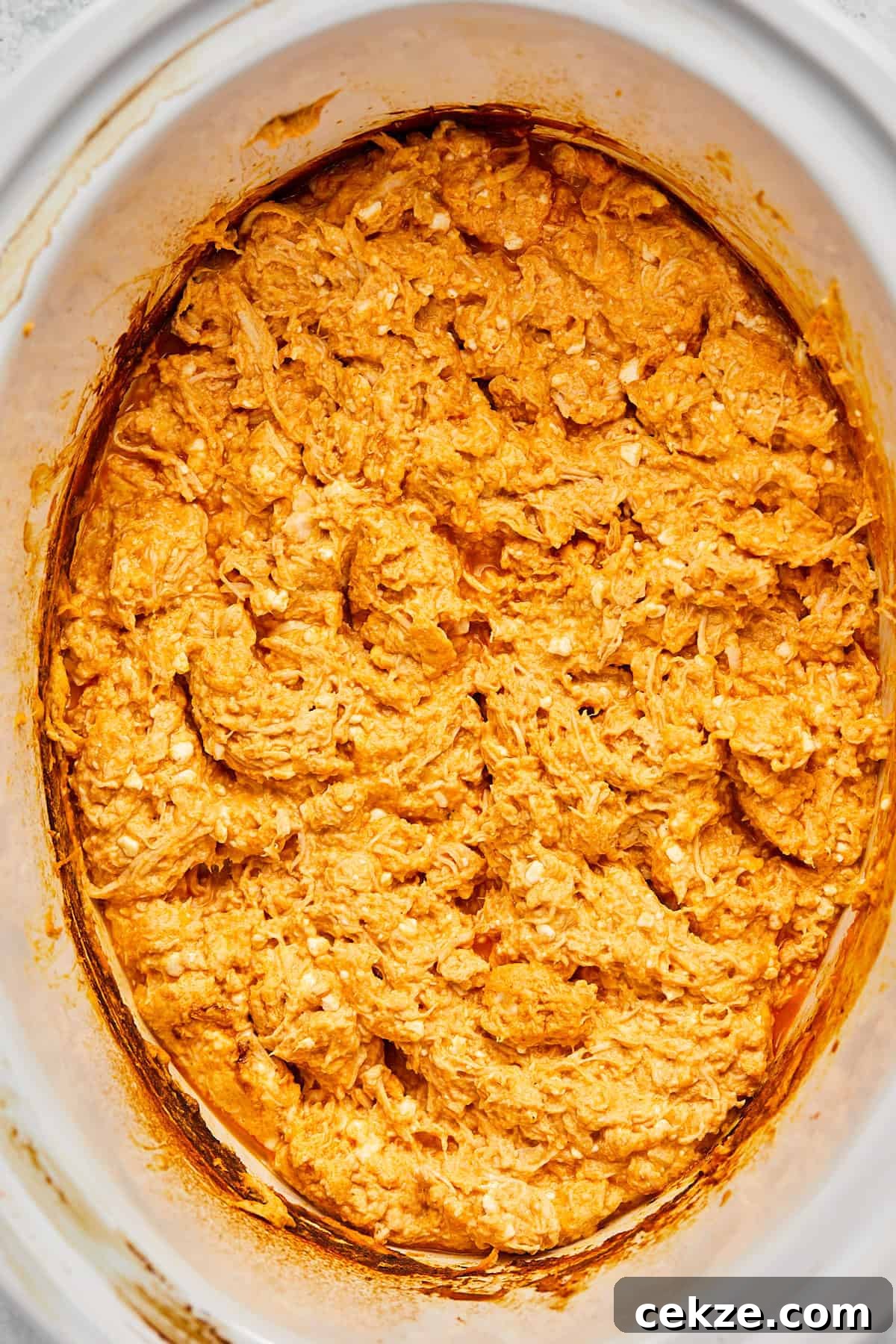 buffalo chicken dip combined in a crock pot