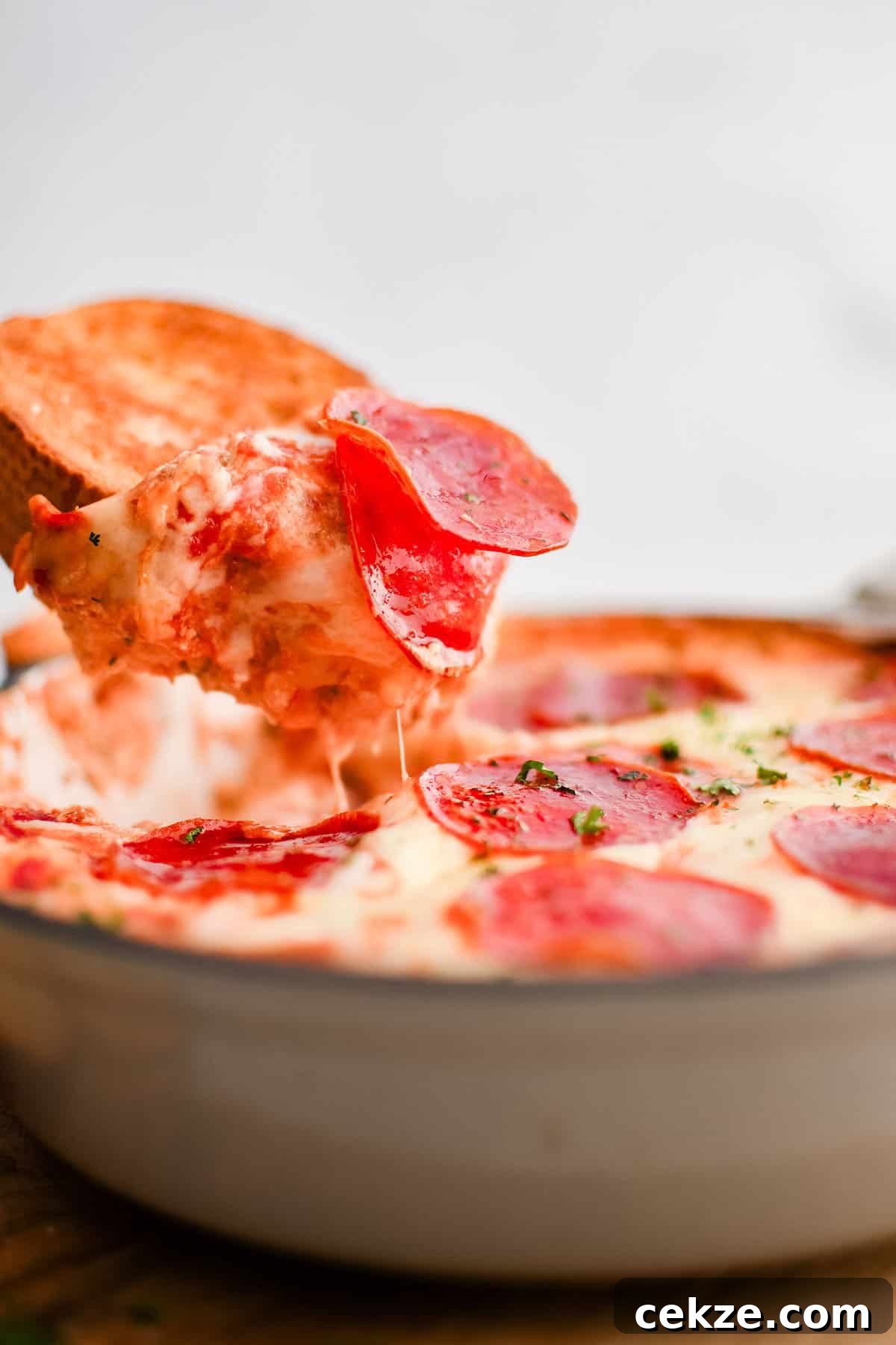photo of pizza dip on a slice of garlic bread