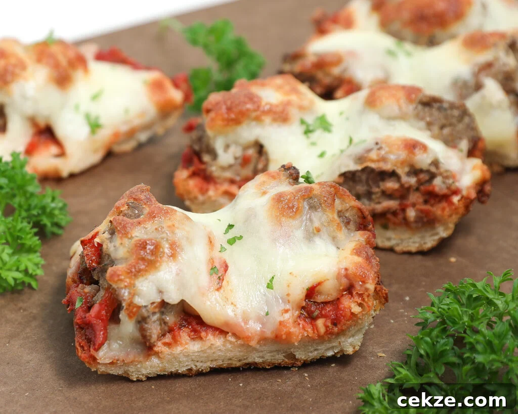 Meatball French bread pizza with melted mozzarella, homemade sauce, and fresh parsley on toasted French bread