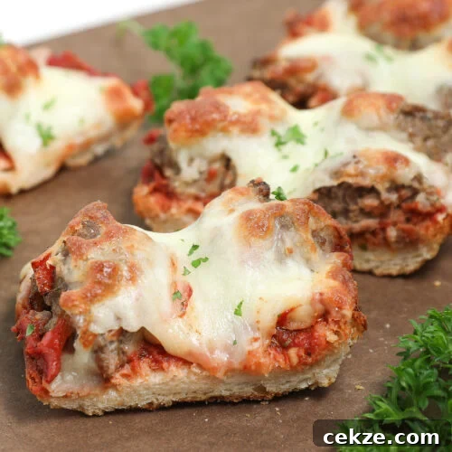 Meatball French bread pizza with melted mozzarella, homemade sauce, and fresh parsley on toasted French bread