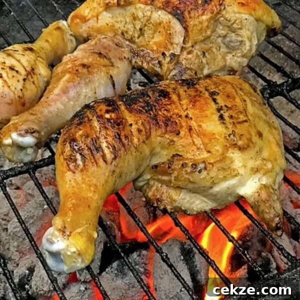 Chicken leg quarter on a hot grill.