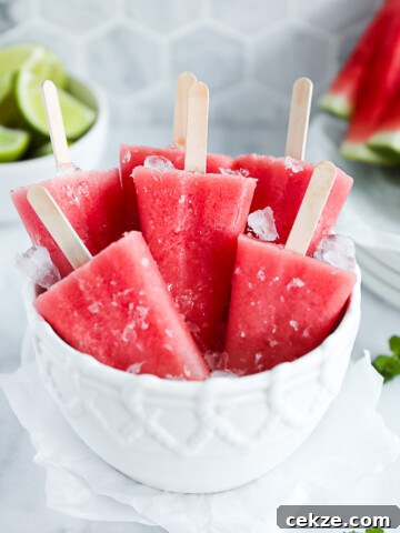 A white bowl filled with crushed ice and watermelon pops.