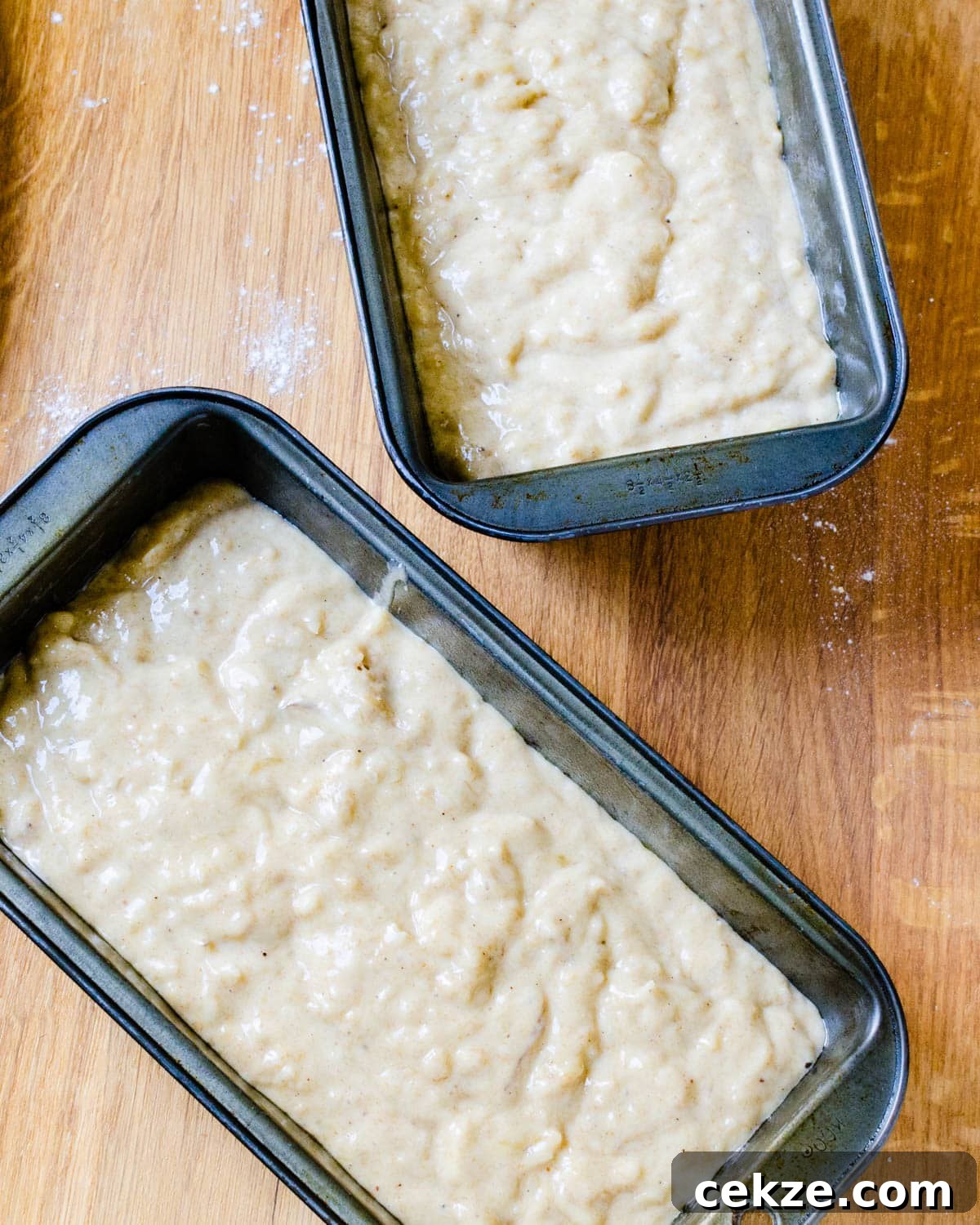 Filling the bread pans with batter.