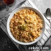 Authentic Egyptian Rice with Toasted Vermicelli Recipe 10 Egyptian rice in a white bowl with two cups of tea in glass mugs.