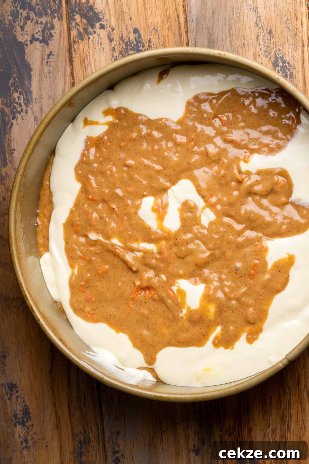 Carrot Cake Cheesecake Recipe: Moist Layered Dessert with Cream Cheese Frosting 8 Cheesecake and carrot cake swirled together.