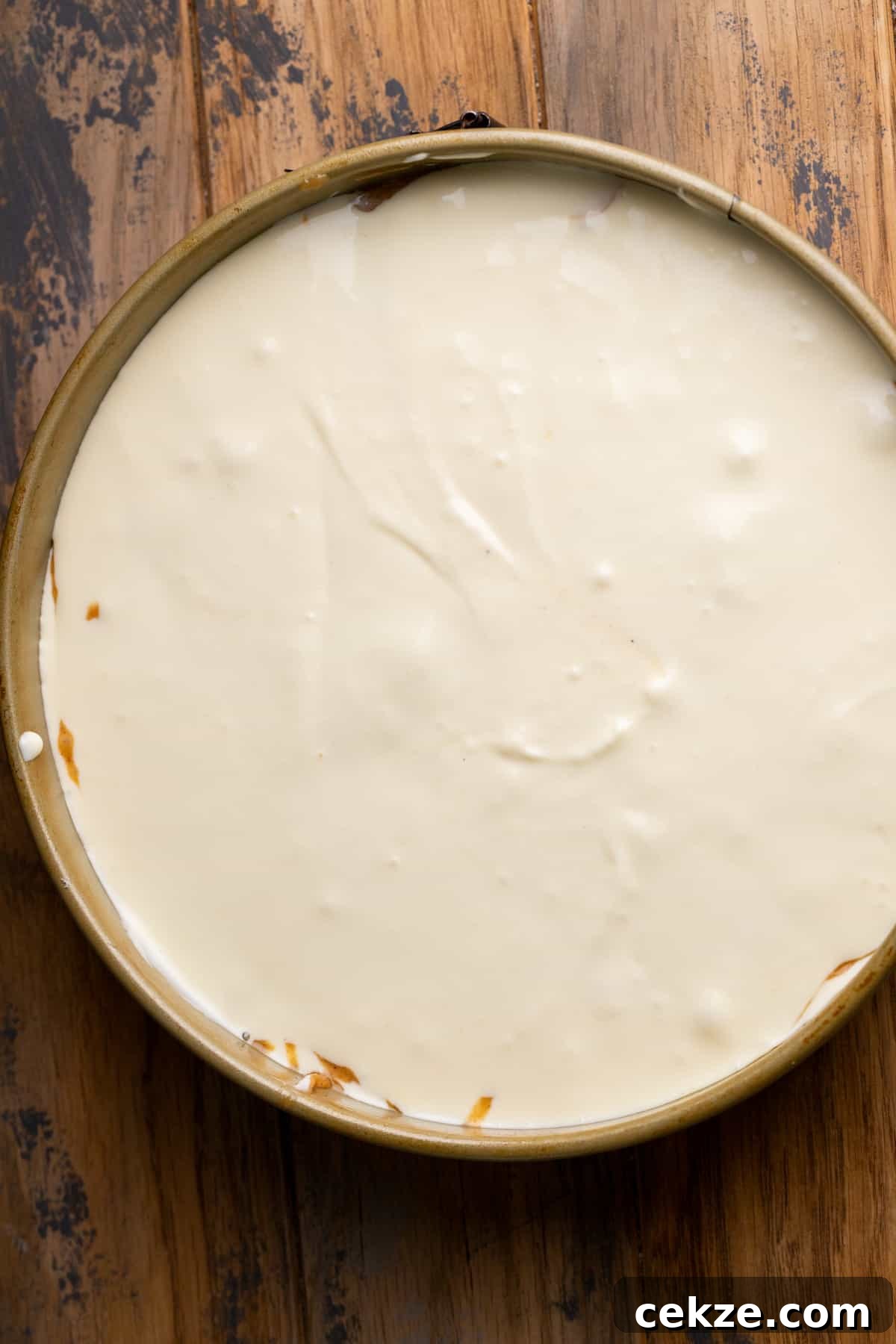 Carrot Cake Cheesecake Recipe: Moist Layered Dessert with Cream Cheese Frosting 9 Cheesecake batter in springform pan.