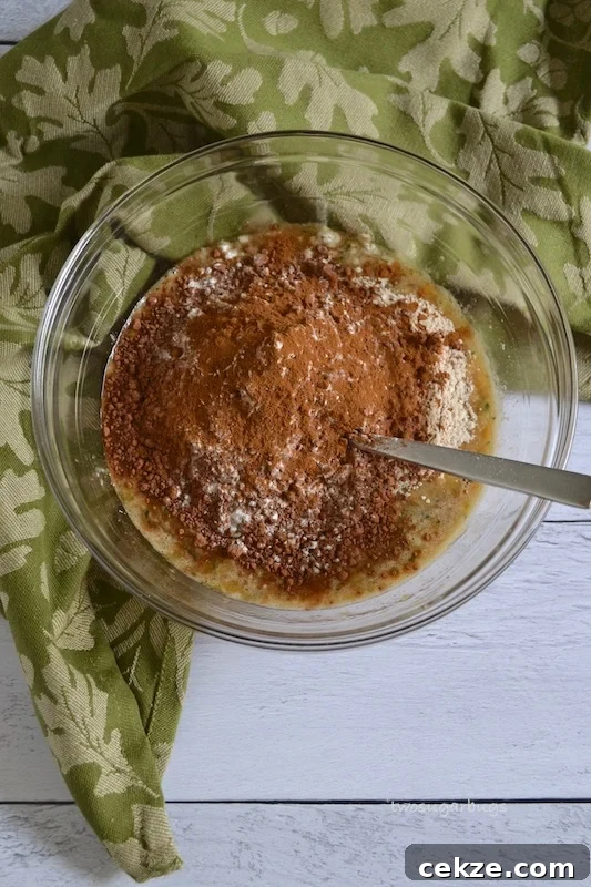 Chocolate Zucchini Bread with Less Sugar and Moist Texture 6 Dry ingredients on top of wet ingredients in a glass bowl