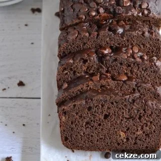 Chocolate Zucchini Bread with Less Sugar and Moist Texture 10 Overhead shot of chocolate zucchini bread on parchment paper
